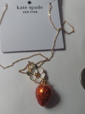 Kate Spade New York necklace features a gold-tone strawberry.